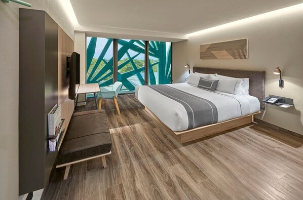 A modern hotel room with a large bed, a desk, and a TV. - King Room w/ Breakfast | Pool Near Paseo Montejo (Mérida)