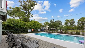 A swimming pool with lounge chairs and a deck area. - Updated Condo with pool within walking distance to beach (North Myrtle Beach)