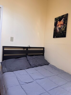 A bed with a headboard, two pillows, and a wall-mounted painting of a fox. - The Loft at New Frontiers Retreat, group/large family lodge in country setting . (North Algona Wilberforce)