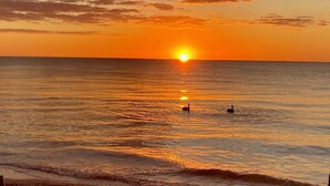 A sunset over the ocean with a clear sky and calm water. - Sweet SUITE on St. Pete Beach -- Perfect for your Beach Getaway (St. Pete Beach)