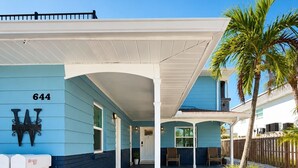 A two-story building with a covered porch, numbered 644, and a mailbox. - Sweet SUITE on St. Pete Beach -- Perfect for your Beach Getaway (St. Pete Beach)