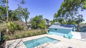 A backyard with a swimming pool, a blue shed, and a wooden fence. - Hidden Gem: Private 650sq ft Studio, Free Parking, Pool, Walkable, Near Downtown (St. Augustine)
