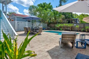 A backyard with a swimming pool, patio furniture, and a covered seating area. - Hidden Gem: Private 650sq ft Studio, Free Parking, Pool, Walkable, Near Downtown (St. Augustine)
