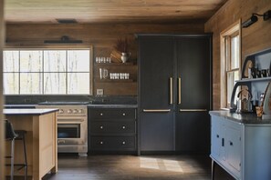 A kitchen with a double-door refrigerator, a built-in oven, and a wooden countertop. - New Luxury Lakeside Cabin with Sauna & Cedar Hot Tub - The Narrows (Pillager)