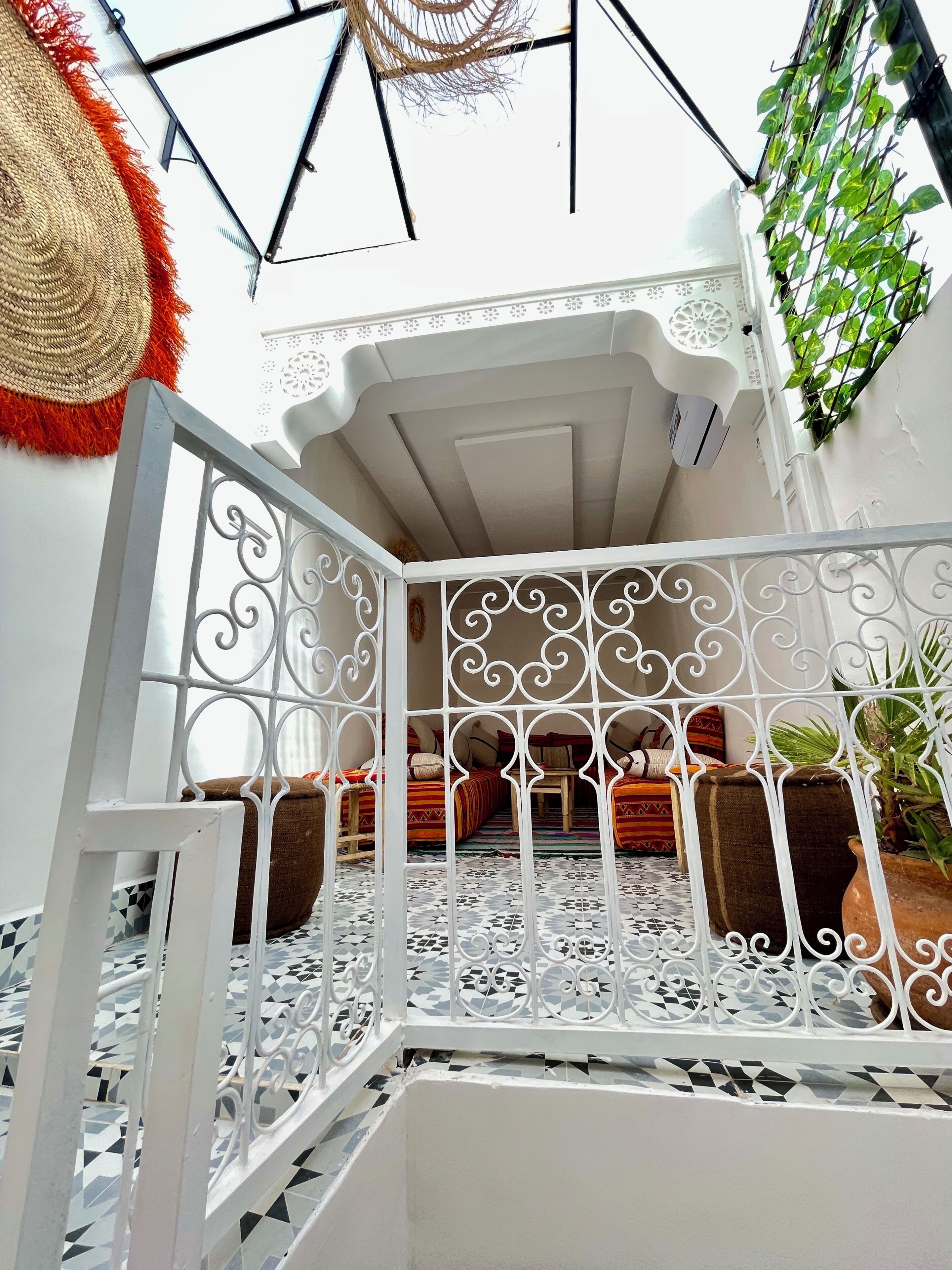 A room with a geometric patterned floor, a white ceiling, and a decorative metal partition.