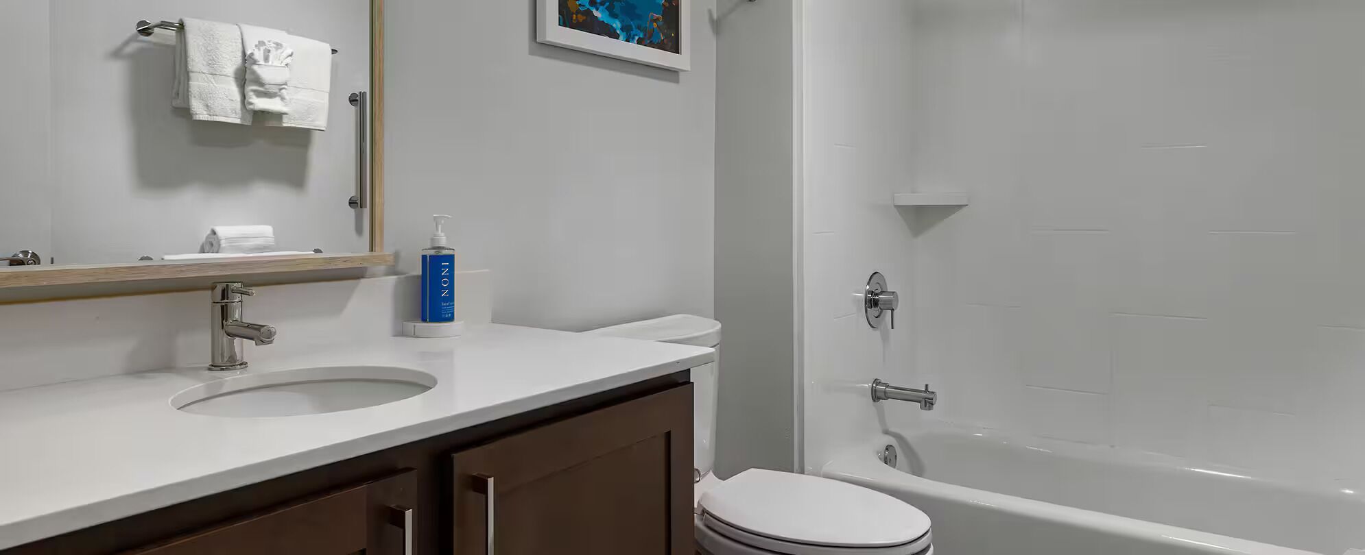 A bathroom with a sink, toilet, and bathtub.