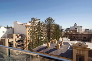 A cityscape with a mix of modern and traditional architecture, including buildings with flat roofs and chimneys, and a clear blue sky. - The Chapter - Luxury Harbour Apt - Newcastle East (Newcastle)