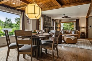 A modern interior with a dining area, seating, and a view of the outdoors. - The Banner Elk Collection | 3 Units | Sleeps 12 (Banner Elk)