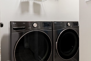 A front view of two LG ThinQ front-loading washing machines. - Bright & Relaxing 2BR near Ballantyne (Charlotte)