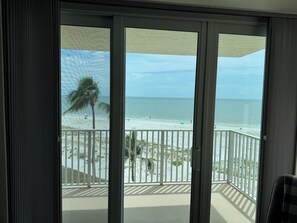 A balcony with a view of the beach and ocean. - Estero Beach & Tennis - Where Every Stay Comes with a WATERFRONT VIEW 405C (Fort Myers Beach)