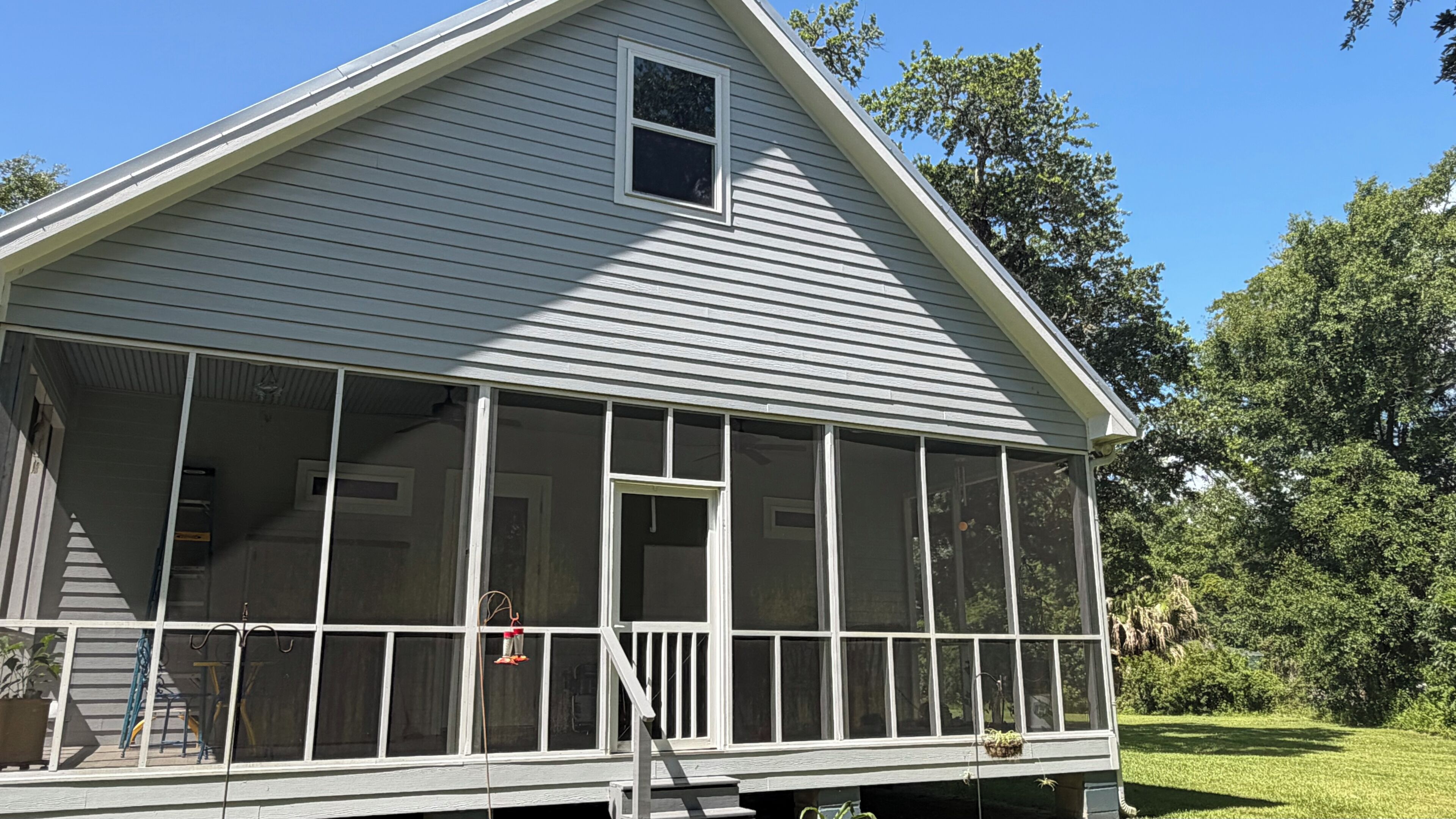 A house with a covered porch, a small window, and a door.