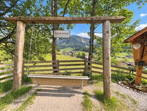 A wooden swing set with a sign reading 'brxental' in a rural setting with a mountain view. - Das Weidach by Interhome (Brixen im Thale)