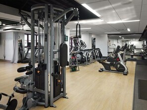 A gym with various exercise machines, a weight rack, and a mirror. - 1 Bedroom Villa at Marriott MountainSide Resort (Park City)