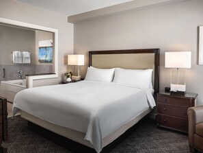 A hotel room with a large bed, bedside lamps, a nightstand, a mirror, and a view of the bathroom. - 1 Bedroom Villa at Marriott MountainSide Resort (Park City)