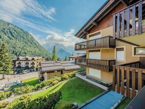A modern hotel with a balcony, surrounded by lush greenery and mountains. - Presanella by Interhome (Madonna di Campiglio)