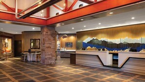 A hotel lobby with a reception desk, seating area, and a large mural. - 2 Bedroom Villa at Marriott MountainSide Resort (Park City)