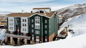 A multi-story hotel with a central courtyard, surrounded by snow-covered terrain and mountains in the background. - 2 Bedroom Villa at Marriott MountainSide Resort (Park City)