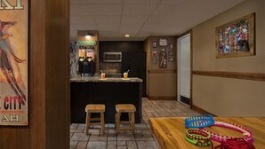 A hotel room with a kitchenette, a bar area, and a wooden table with knitting supplies. - 2 Bedroom Villa at Marriott MountainSide Resort (Park City)