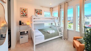 A bunk bed room with a desk, a small fridge, and a window with a view of the outside. - Cozy Ensuite Room Near Mt. Rainier & Seattle (Bonney Lake)