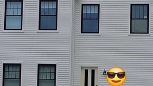 A two-story building with a symmetrical facade, a central entrance with a door, and a small porch with steps leading up to the door. - Spacious 4-bedroom lake house in Shrewsbury MA.   (Shrewsbury)