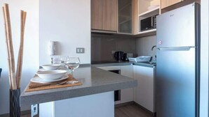 Una cocina moderna con una isla integrada, electrodomésticos de acero inoxidable y armarios de madera.