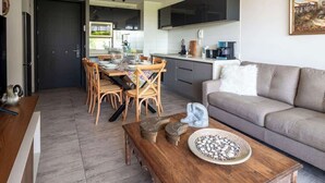 Uma cozinha moderna com área de refeições, um sofá e uma mesa de centro.