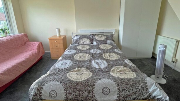A bedroom with a bed, a dresser, a radiator, and a window. - Entire 2 Large Double Bedrooms First Floor Apartment (No lounge) (London)