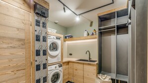 A compact kitchen with a washing machine, a sink, and a stainless steel refrigerator. - Spacious apartment, lake view - 14 guests (Tignes)