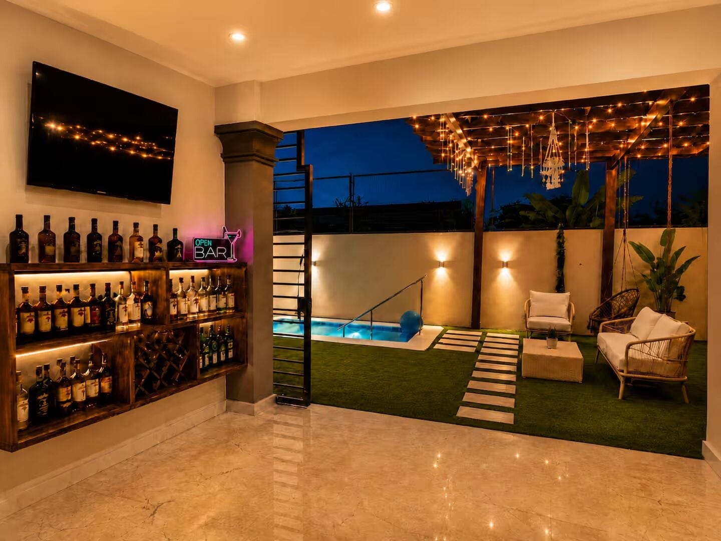 A bar area with a pool and outdoor seating.