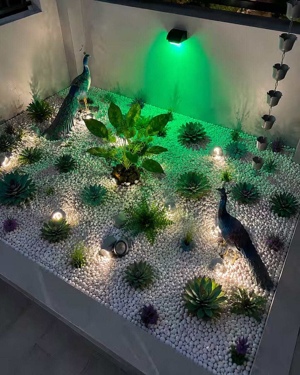 A decorative garden with peacocks, a central water feature, and various plants.