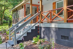 A house with a wooden staircase leading to a covered porch. - Ruby's Coop (Bryson City)
