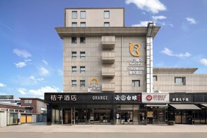 A hotel with a modern facade, multiple windows, and signage indicating it is a youth hotel. - Xiaobai Youth Hotel (Beijing)