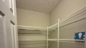 A storage closet with metal shelving units and a door. - Minutes to Beach - Cozy Townhouse in PCB (Panama City Beach)