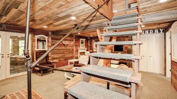 A wooden interior with a stone staircase, a laundry room, and a view of the outside.