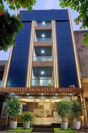 A hotel with a modern facade, featuring a prominent sign for 'Hotel Signature Suites'. - Hotel Signature Suites (New Delhi)
