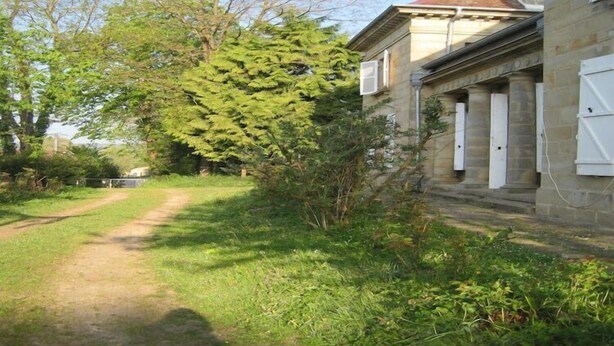 A pathway leading to a building with a red roof and stone walls. - Castle with Private Park & Tennis (Anrosey)
