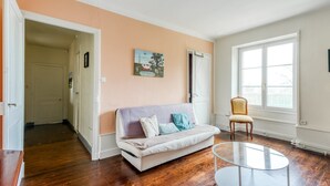 A living room with a sofa, a glass coffee table, a chair, and a large window. - Castle with Private Park & Tennis (Anrosey)