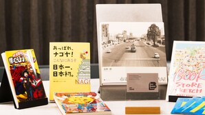 A collection of books and a postcard on a table. - R Hotel Nagoya Station (Nagoya)
