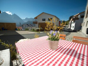 A red and white checkered tablecloth with a potted plant on a table.
