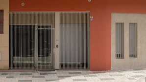 A building facade with a double door and a window. - Brand-new apartment with an accessible bathroom and kitchen. Perfect for families! (Nerja)