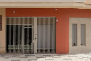 A building facade with a double door and a window. - Brand-new apartment with an accessible bathroom and kitchen. Perfect for families! (Nerja)