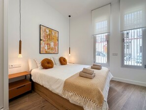 A bedroom with a bed, bedside tables, a bench, a window, and a painting. - Brand-new apartment with an accessible bathroom and kitchen. Perfect for families! (Nerja)