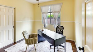 A room with a desk, two chairs, a ceiling fan, a window with curtains, and a door. - Pool & Hot Tub Access! Oceanside Escape Near Golf (Oceanside)