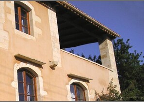 A building with arched windows and a balcony. - Kamares – a restaured Venetian domain retreat (Macheri)