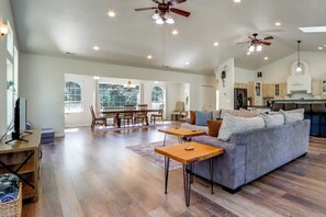 A spacious living area with a sofa, coffee table, and dining table. - Riffle Road Ranch: 10 Acres, 8 Mi to Silverwood (Spirit Lake)