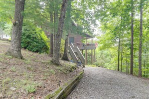 A cabin with a wooden staircase leading to a porch, surrounded by trees and a gravel path. - Blue Ridge Bliss: Peaceful Retreat w/ Deck (Blue Ridge)