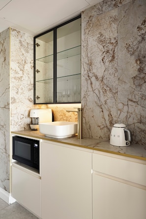 A modern kitchen with a built-in microwave, a white sink, and a coffee maker on the countertop. - 
ForeverSunday Coastal* - Stay on the Golden Mile  - right in the heart of Manly (Manly)