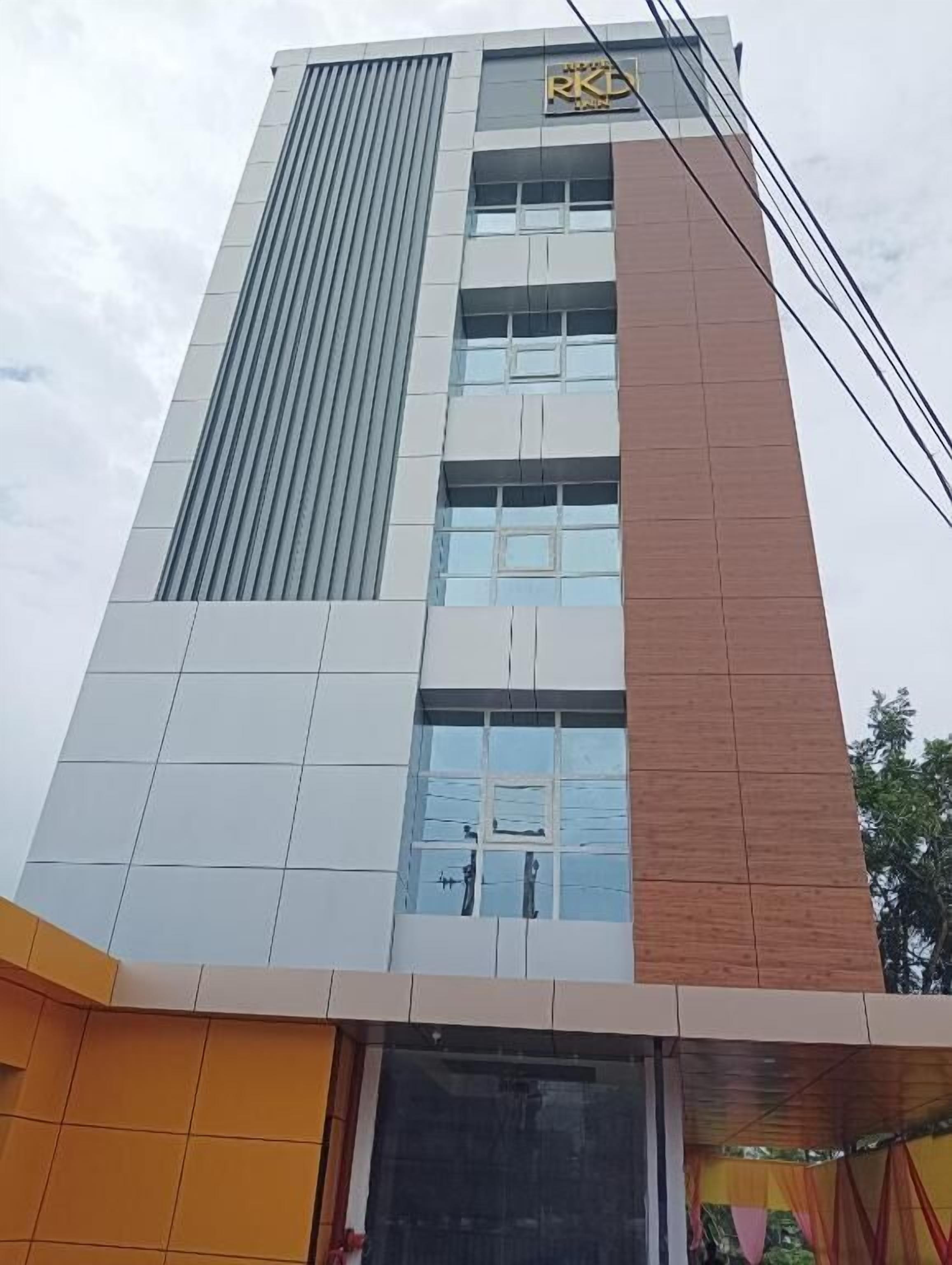 A multi-story building with a prominent logo at the top, large windows, and a modern architectural design.