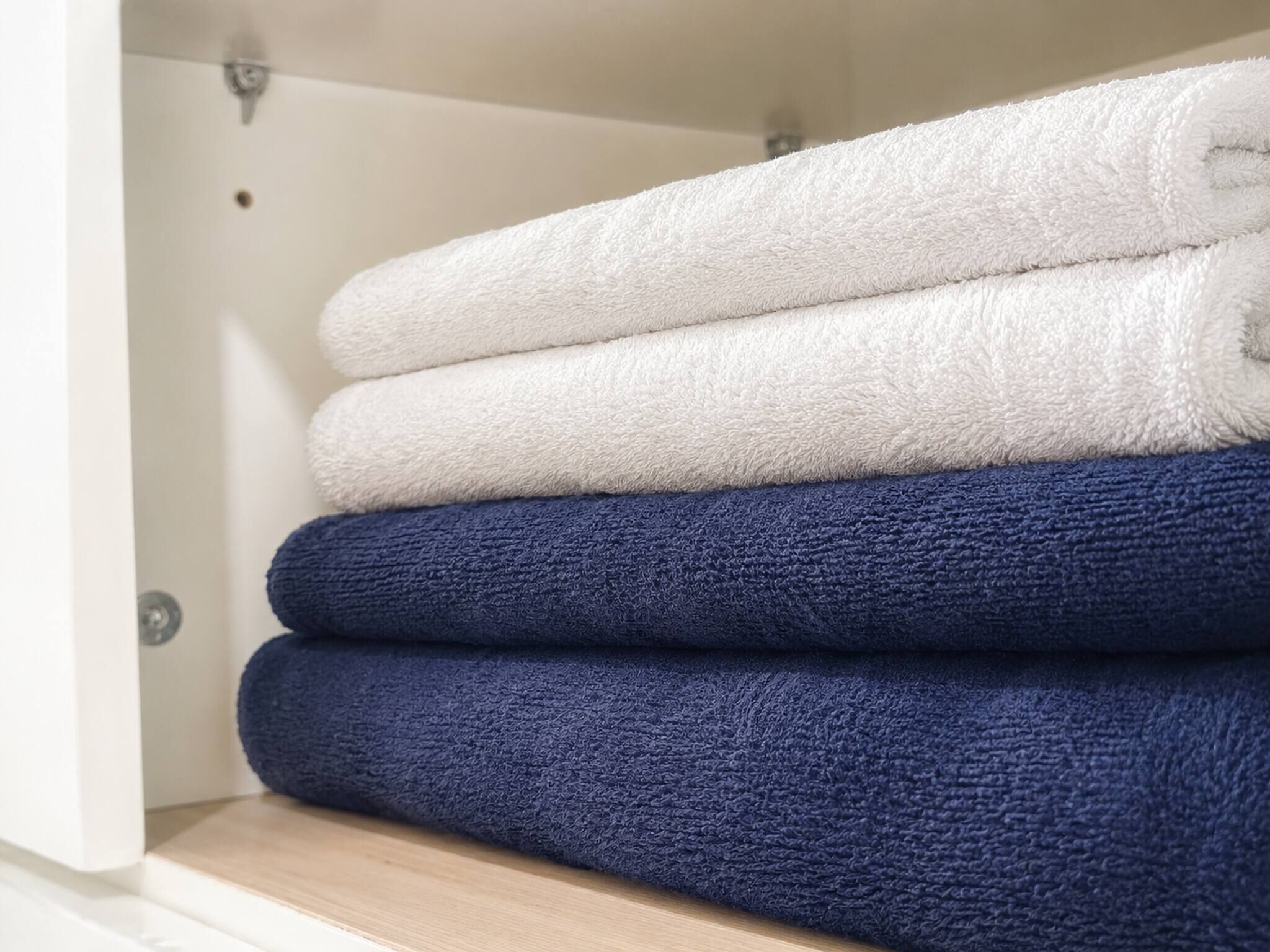A stack of folded towels in a bathroom.