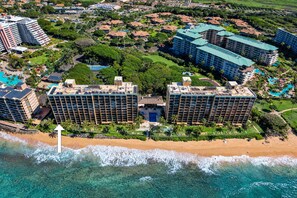 A resort with multiple high-rise buildings, a beachfront, and a pool area. - Oceanfront Retreat with Panoramic Views & Beachfront Lanai -Mahana 109 (Lahaina)